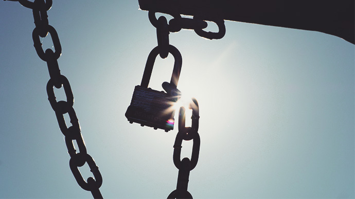 An abstract depicting the breaking of oppression by melting of the chains that bind and lock individuals, by the marvelous powers of love and peace, composed in the hot Sonoran Desert of  Peoria,Arizona,USA, with a master-lock and a chained gate during a hot Summer day of June, 2020.