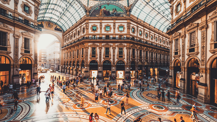 What to Know Before Moving Assets Abroad Crowd of people in Galleria Vittorio Emanuele II at sunset, Milan, Italy