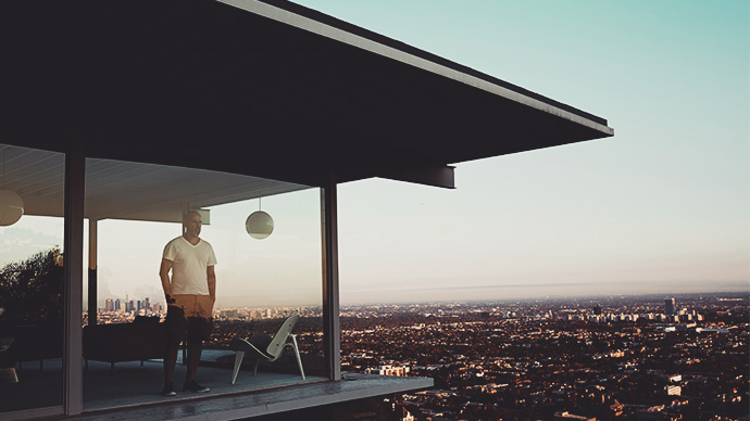 Man Standing In House Overlooking Los Angeles