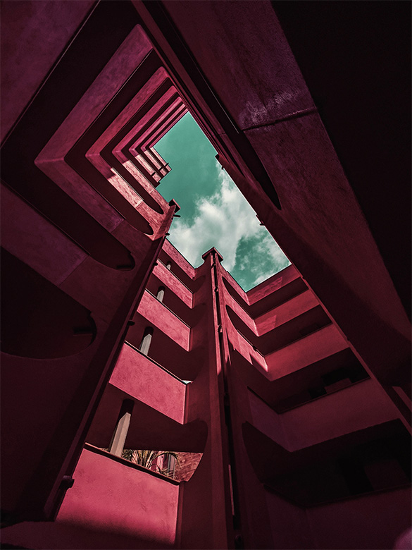 Ceramic building with red color and levels, with community areas for residents in high density population building in the southern of Europe.